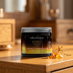 Amber Treat Shea Butter Body Balm 200 ml on a honey-toned wooden vanity with pieces of amber