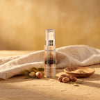 Argan Oil 50 ml on warm stone with argan nuts and a linen cloth