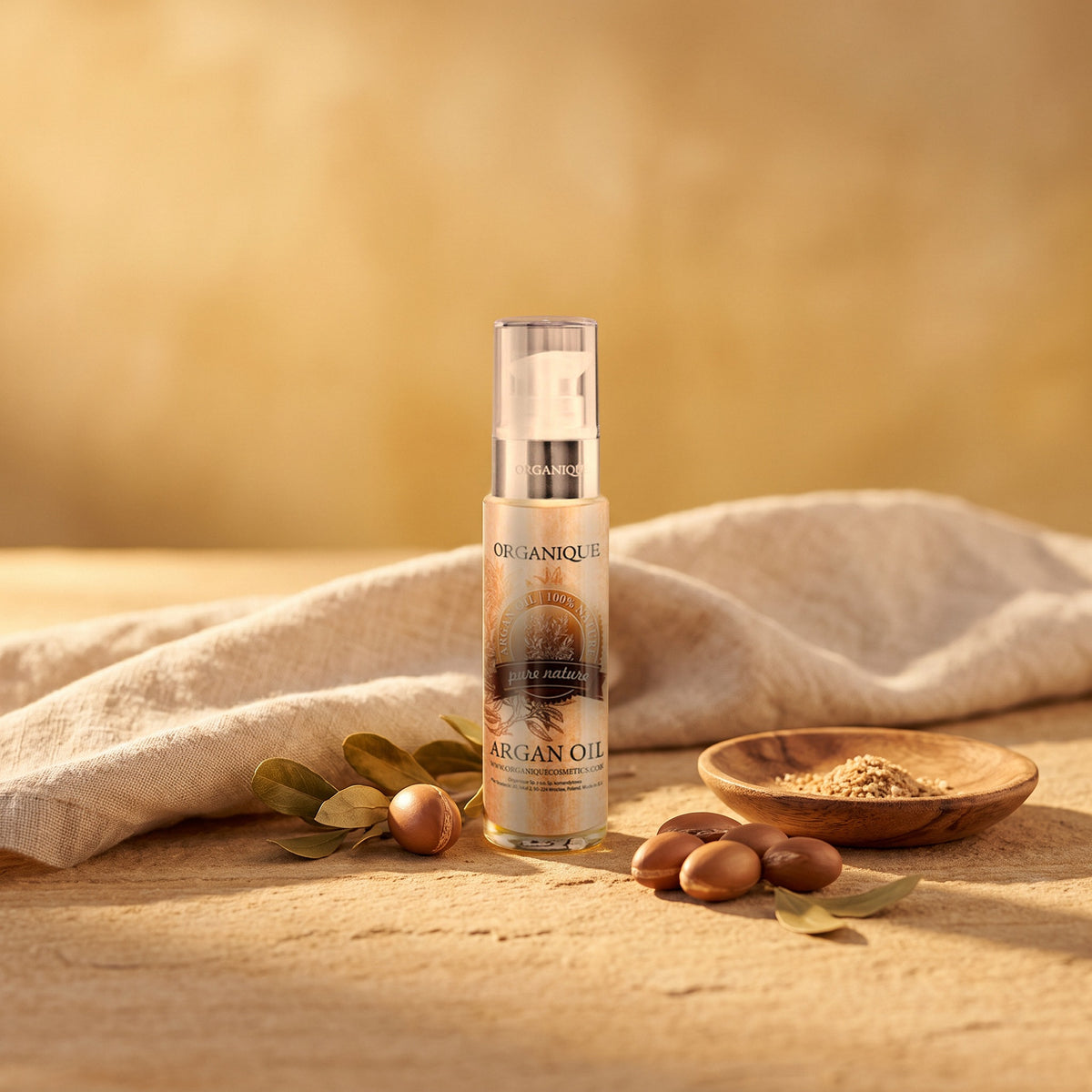 Argan Oil 50 ml on warm stone with argan nuts and a linen cloth