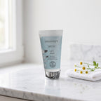 Basic Care Hydration Face Mask 50 ml on a white marble vanity with a face cloth and chamomile