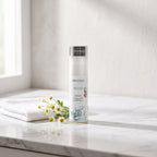 Basic Cleaner Gentle Face Wash 200 ml on a white marble vanity with a face cloth and chamomile