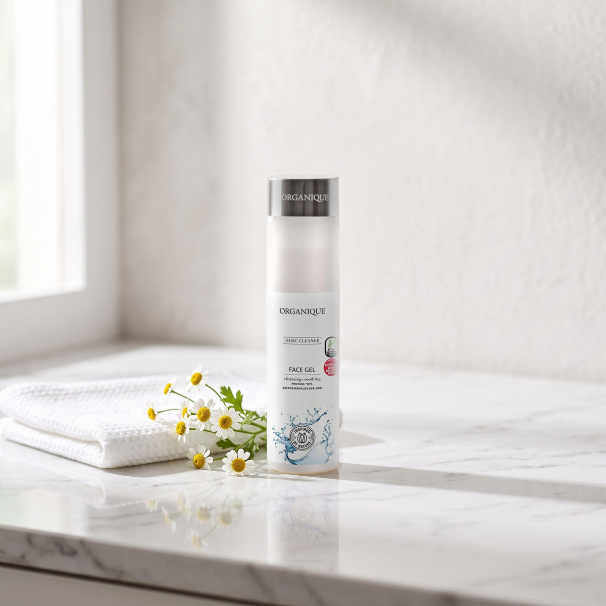 Basic Cleaner Gentle Face Wash 200 ml on a white marble vanity with a face cloth and chamomile