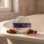 Bath Bomb – Winter Punch on the rim of a bathtub with cinnamon, star anise and cranberries
