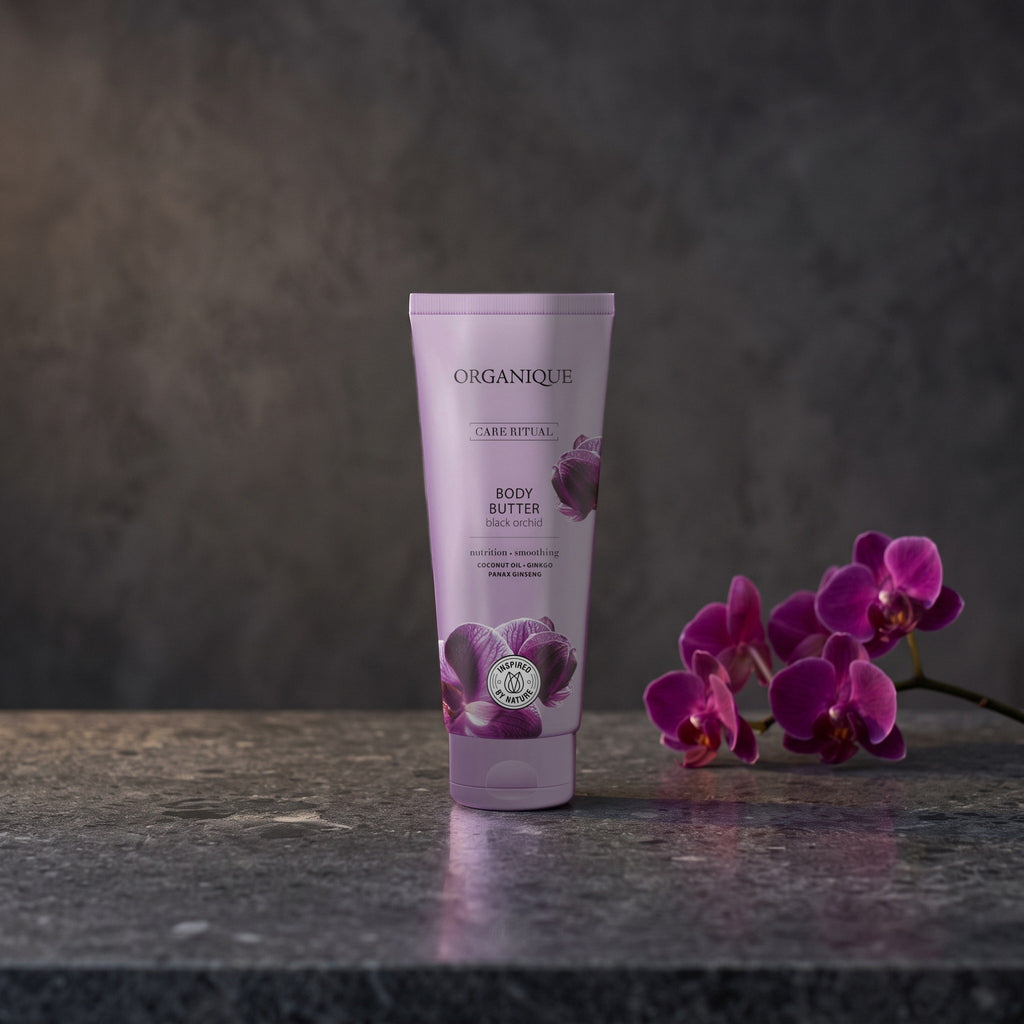 Black Orchid Body Butter 200 ml on a dark stone vanity with purple orchids