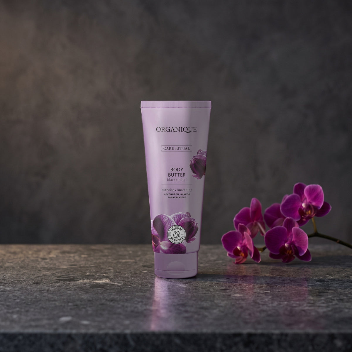 Black Orchid Body Butter 200 ml on a dark stone vanity with purple orchids