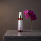 Body Mist – Black Orchid 100 ml on a dark stone vanity with purple orchids