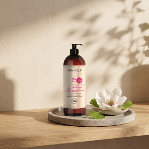 Gentle Shower Gel – Ginkgo Biloba 1000 ml on a bathroom shelf with a magnolia flower and ginkgo leaves