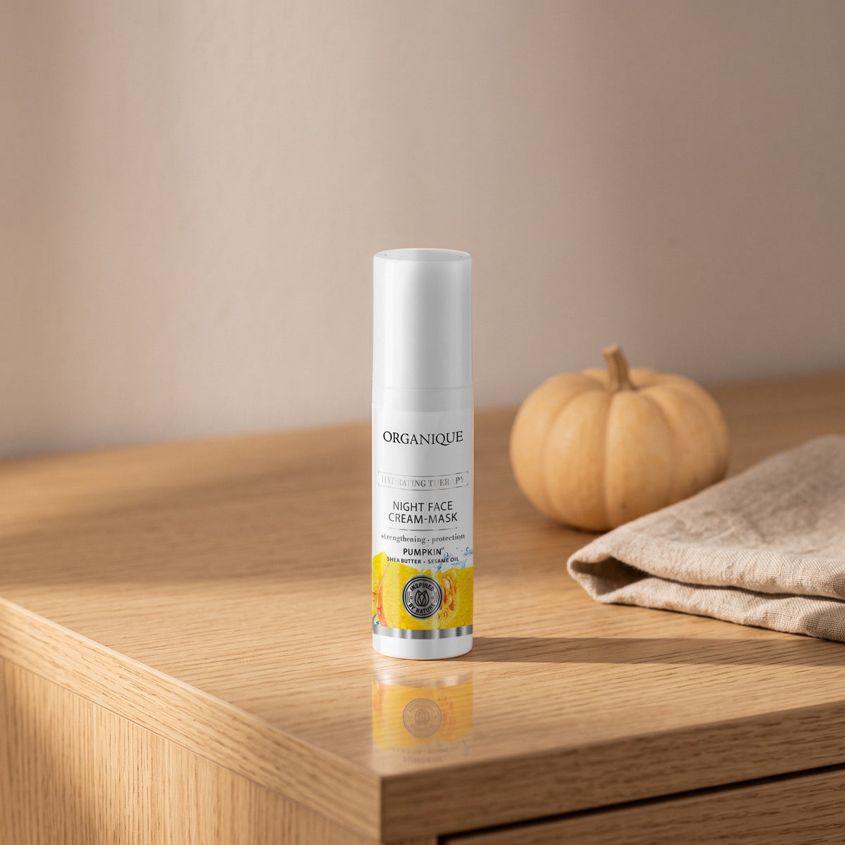 Pumpkin Night Cream Mask 50 ml on an oak vanity with a small pumpkin