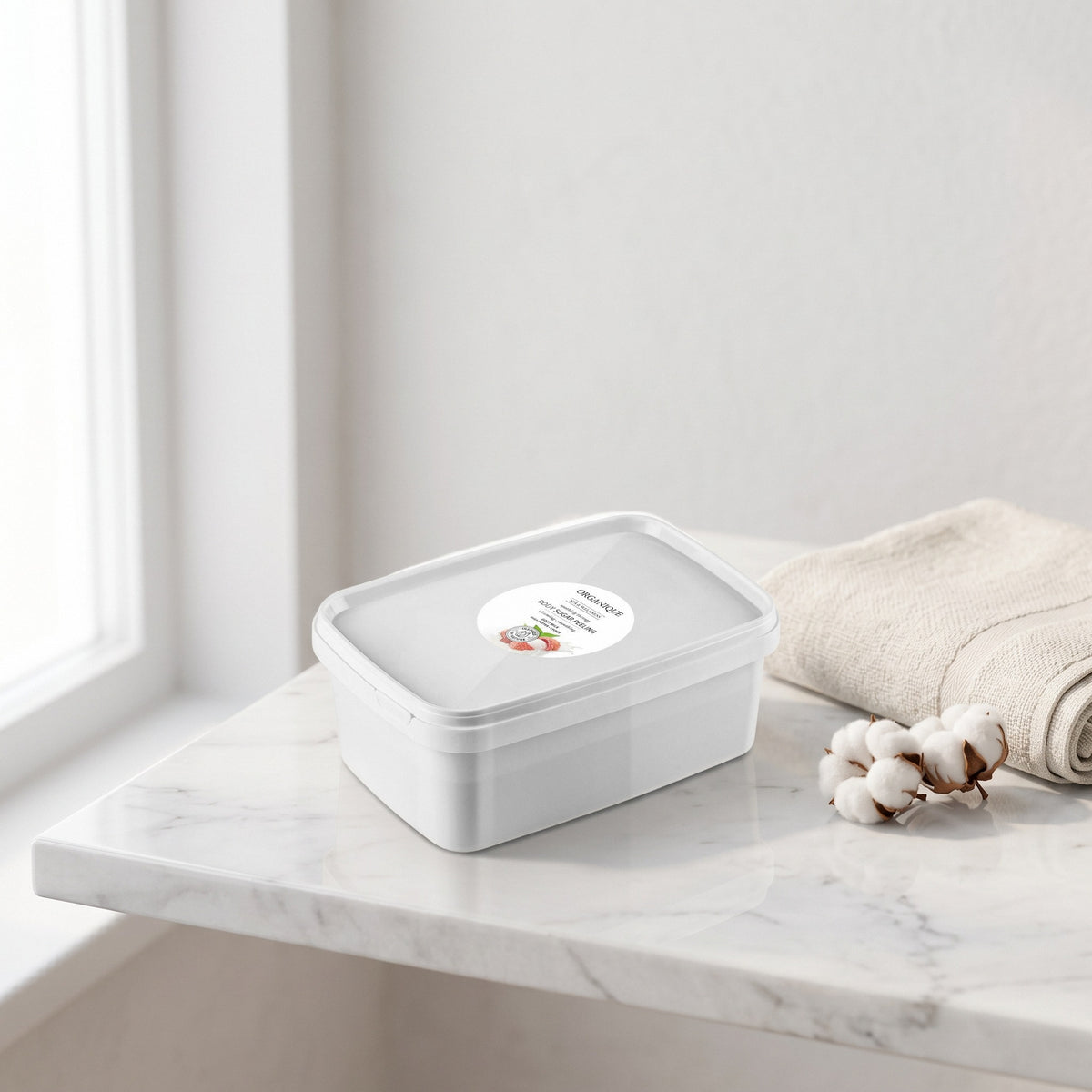 Milk Sugar Scrub 1 kg on a white marble ledge with a linen towel and cotton flowers