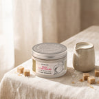 Milk Sugar Scrub 450 ml on linen with sugar cubes and a jug of milk