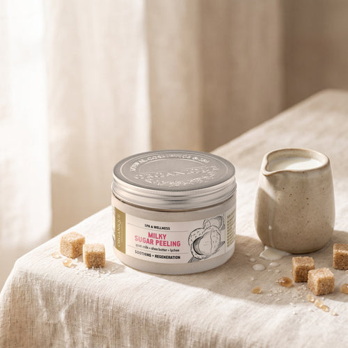 Milk Sugar Scrub 450 ml on linen with sugar cubes and a jug of milk