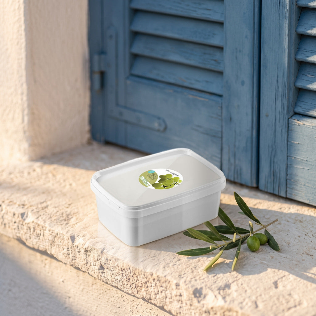 Shea Butter Body Balm – Greek 1 kg on a white-washed stone ledge with olive leaves