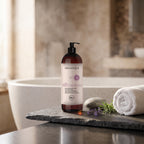 Xeradin Shower Gel 1000 ml on a slate ledge beside a bathtub with a towel