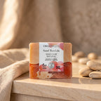 Natural Soap Cube – Sand Mandala 100 g on a sandstone ledge with linen and pebbles